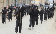 Fighters of  al-Qaeda linked Islamic State of Iraq and the Levant parade at Syrian town of Tel Abyad