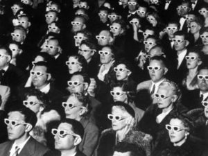 Photo #: 259232 Date Taken:  11-26-1952 Description: 3-D Movie Viewers. Formally-attired audience sporting 3-D glasses during opening night screening of film "Bwana Devil," the 1st full-length color 3-D (aka "Natural Vision") motion picture, at Paramount Theater. City: HOLLYWOOD State: CA Country: US Photographer: J. R. EYERMAN/TimePix